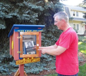 Here I am placing one of my "Murder in Wauwatosa" books in a Free Little Library on Warren Avenue in Wauwatosa this summer. These little libraries are so cool. People come by, pick up a book and leave one.